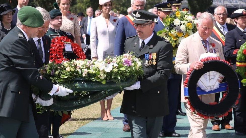 King Philippe of Belgium (second left) and Prince Charles laying floral tributes
