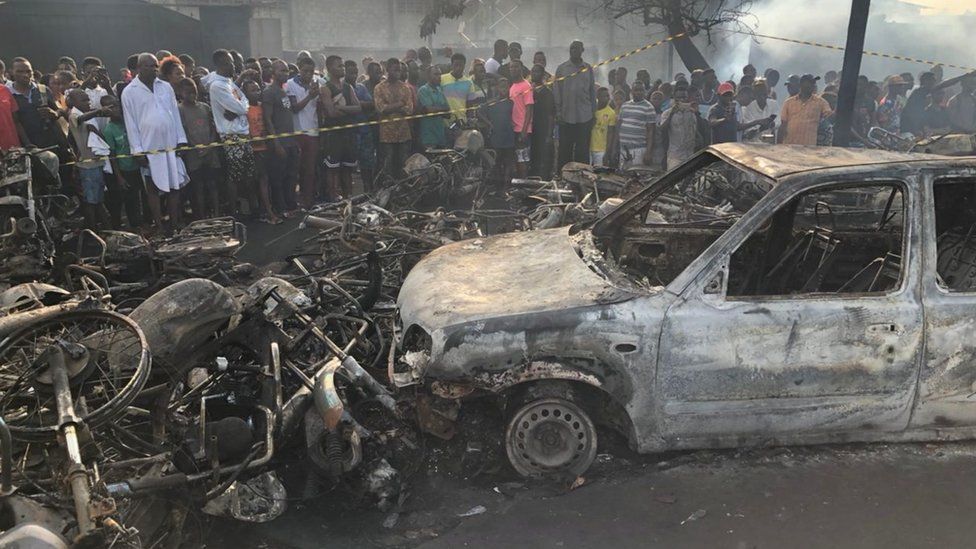 Freetown residents inspect the remains of cars and motorbikes on Saturday morning
