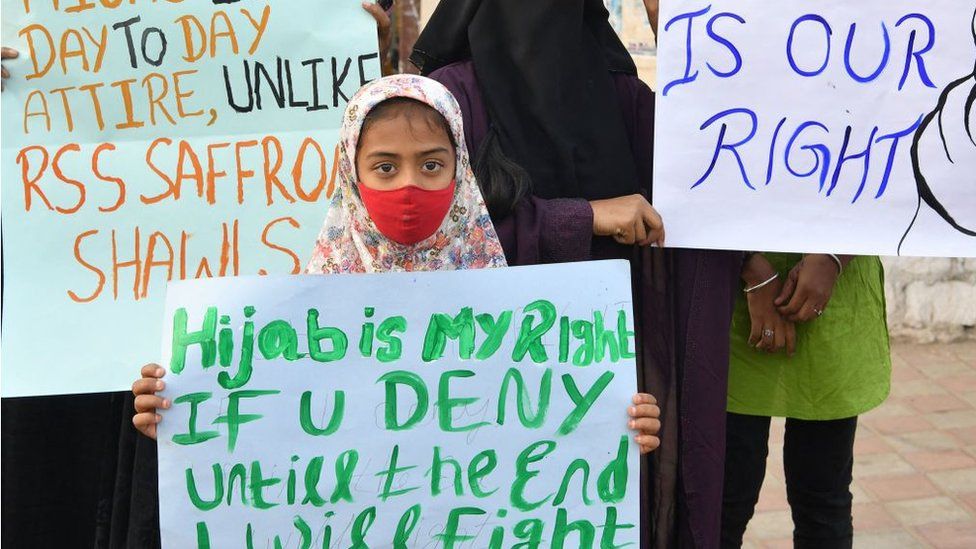 Muslim women hold placards during a demonstration after educational institutes in Karnataka denied entry to students for wearing hijabs, in Bangalore on February 7, 2022.