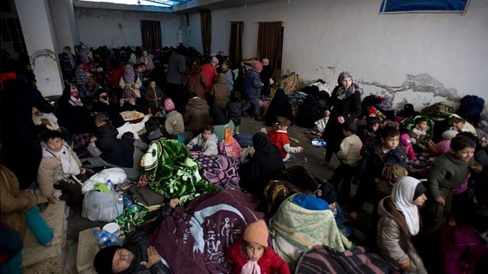 Syrians rest in a camp built by IHH Humanitarian Relief Foundation near Bab al-Salam border gate on Turkey's border in Azez district of Aleppo as they flee to Turkey to escape heavy Syrian regime and Russian airstrikes