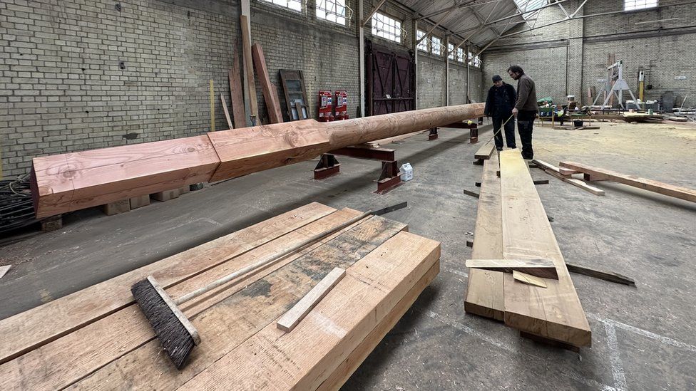 Workers restoring HMS Ganges mast