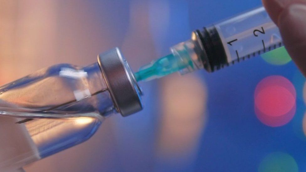 An injection in a vaccine vial