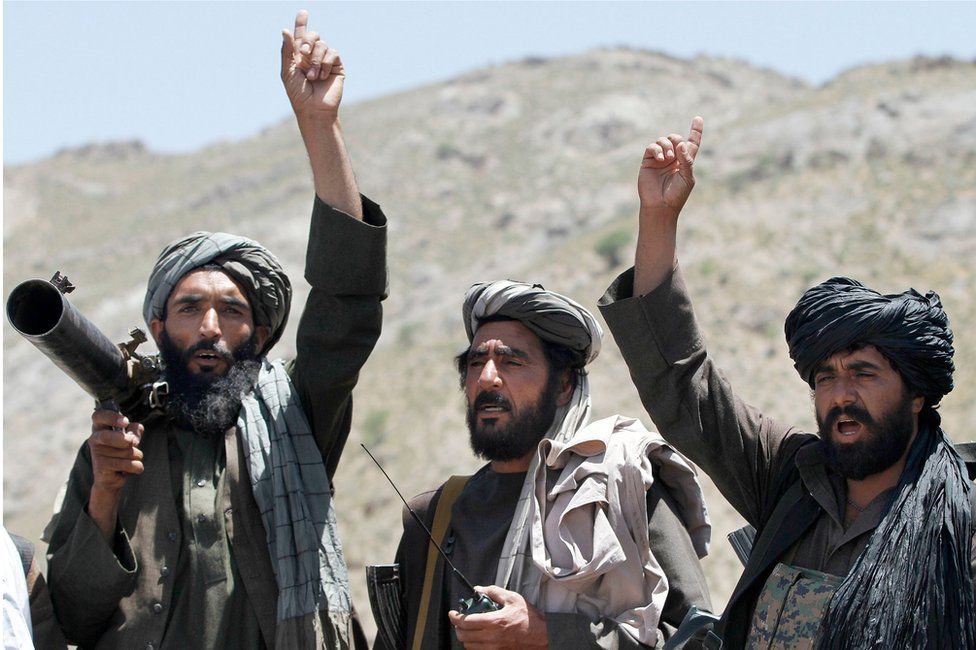 Taliban fighters carrying weapons cheers during a speech by their senior leader in the Shindand district of Herat province, Afghanistan. 27 May 2016.