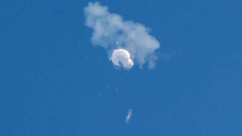 Photo of spy balloon in the air being shot down