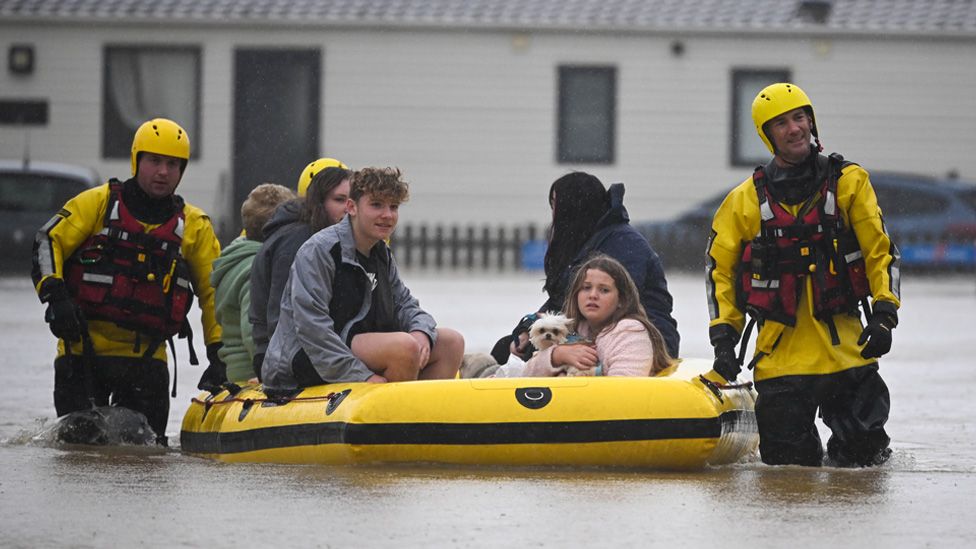 People are rescued from their holiday chalets at Freshwater Beach Holiday Park in Burton Bradstock, Dorset