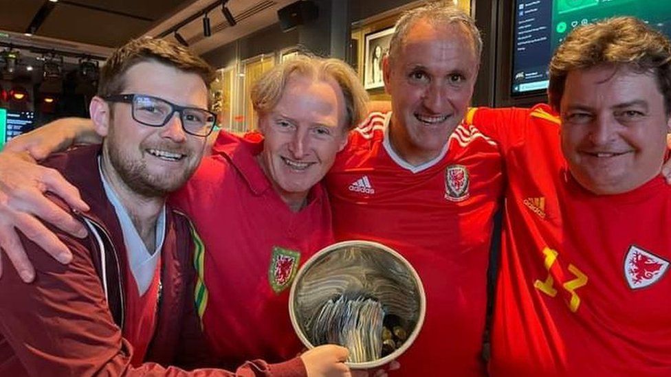 Wales fans with money they have raised