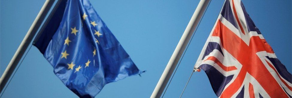 EU flag and Union Jack flying side by side