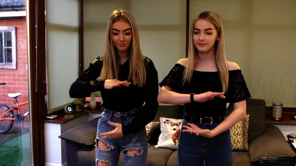 Emily and Lauren dancing as they film themselves on TikTok