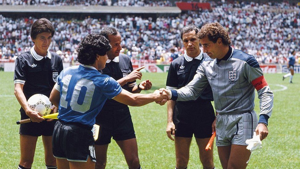 Diego Maradona of Argentina shakes hands with Peter Shilton of England under the watching eye of referee Ali Bin Nasser before the 1986 FIFA World Cup Quarter Final on 22 June 1986 at the Azteca Stadium in Mexico City, Mexico.