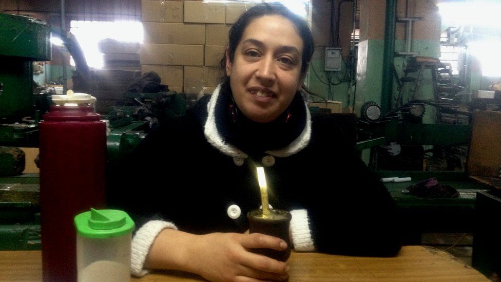 Natalia Sosa drinks mate tea in the factory in which she works