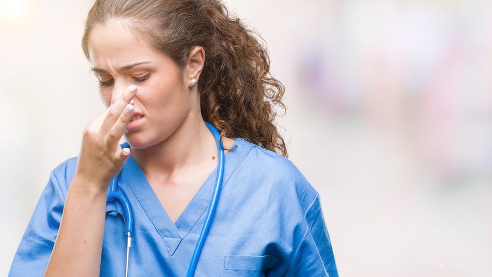 Nurse holding her nose