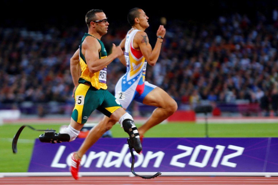 South Africa's Oscar Pistorius (L) runs beside Venezuela's Albert Bravo in the men's 400m semi-final during the London 2012 Olympic Games at the Olympic Stadium August 5, 2012.