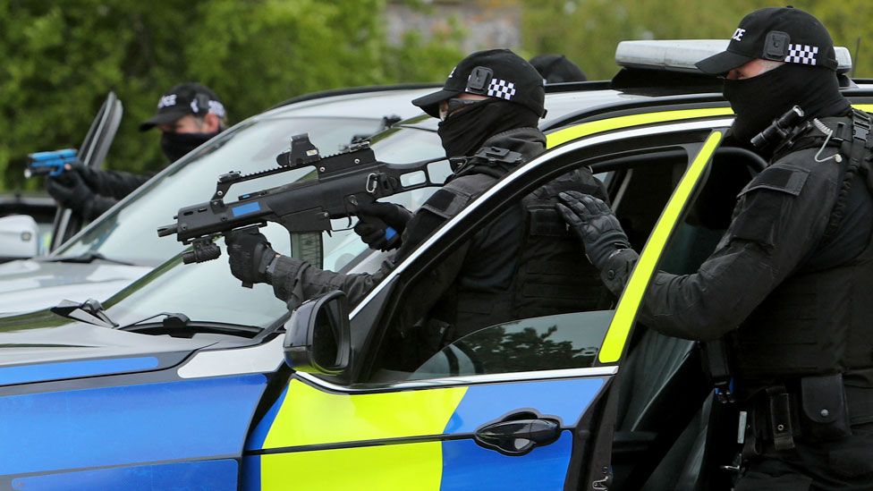 Police firearms officers hold their weapons as they demonstrate a 'compliant stop' during a demonstration for media ahead of the upcoming in-person G7 Summit to be held in Cornwall, at the Police headquarters in Exeter, southwest England on 25 May 2021