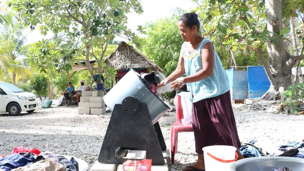 Tenna washing clothes by hand in Kiribati