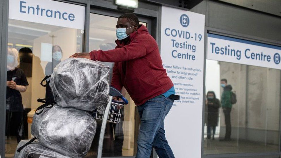 A passenger walks past a novel coronavirus Covid-19 testing site