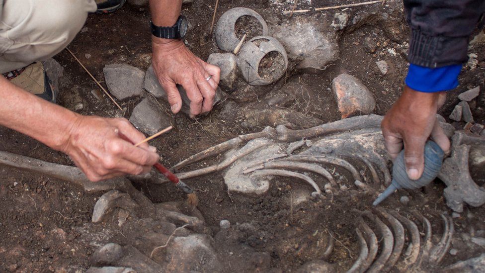 Archaeologists of the Pacopampa Archaeological Project work on the site of the 3,000-year-old tomb