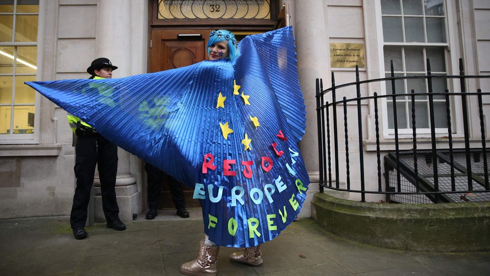 A pro-EU activist wearing a cape decorated with an EU flag design joins a rally organised by civil rights group New Europeans outside Europe House, central London on 31 January ,2020