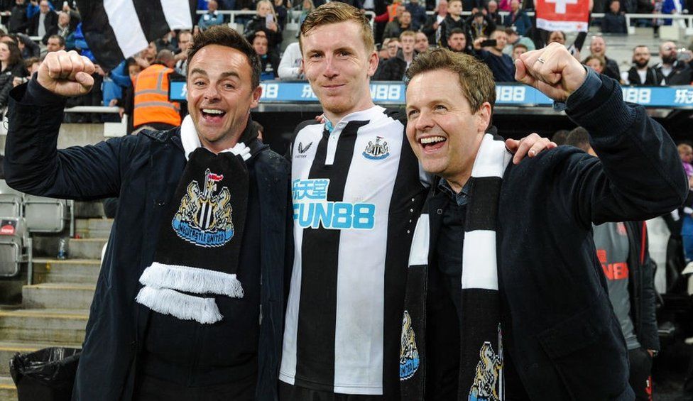 Matt Targett of Newcastle United (13) poses with Ant & Dec after the Premier League match between Newcastle United and Arsenal at St. James Park on May 16, 2022