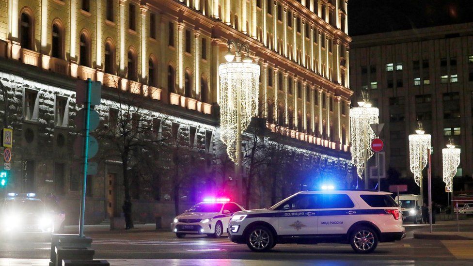 Police vehicles block a street near the Federal Security Service (FSB) building after a shooting incident in Moscow, 19 December 2019