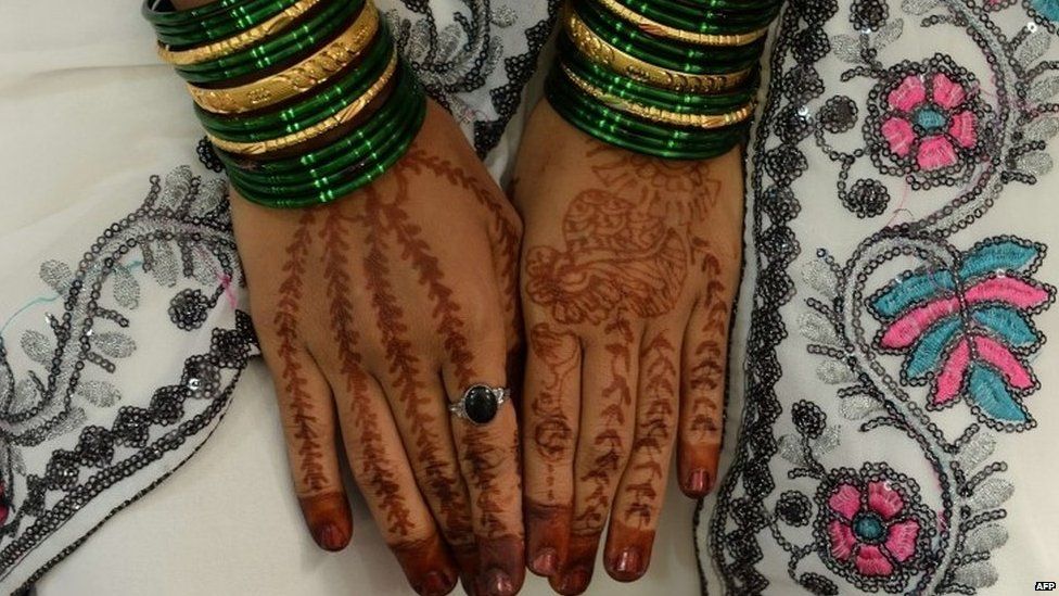 Mehendi (henna)-decorated hands of an Indian bride