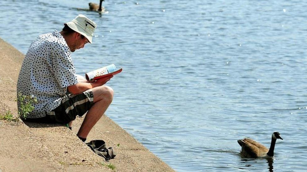 Man reading by River Trent