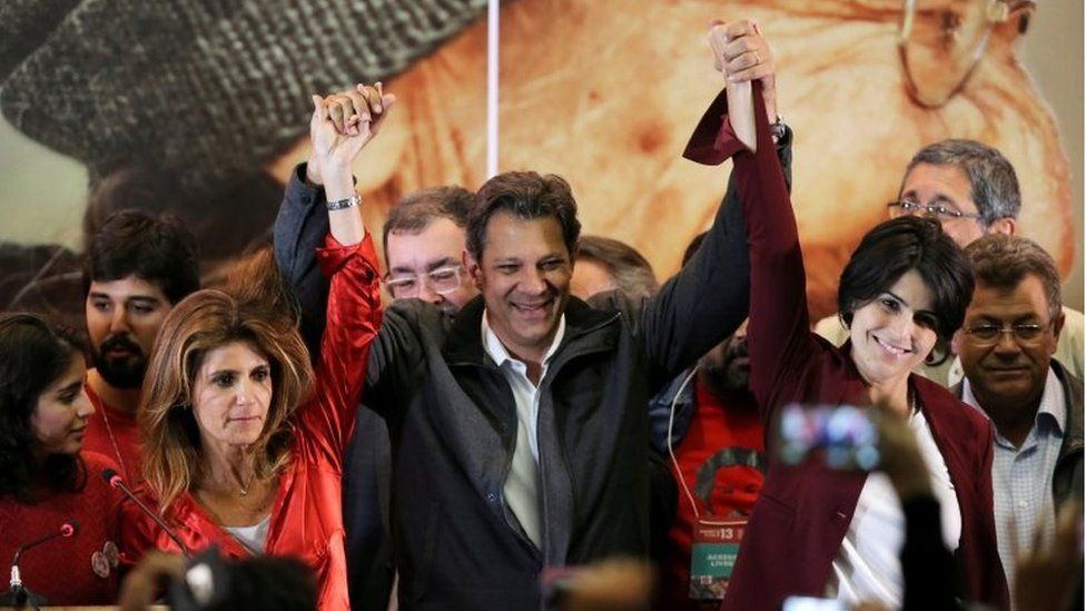 Fernando Haddad (R), presidential candidate of Brazil's leftist Workers' Party (PT), reacts with supporters, in Sao Paulo, Brazil October 7,