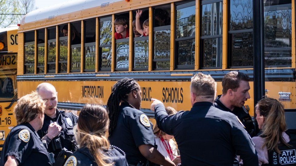 School buses with children arrive at Woodmont Baptist Church to be reunited with their families after a mass shooting at The Covenant School