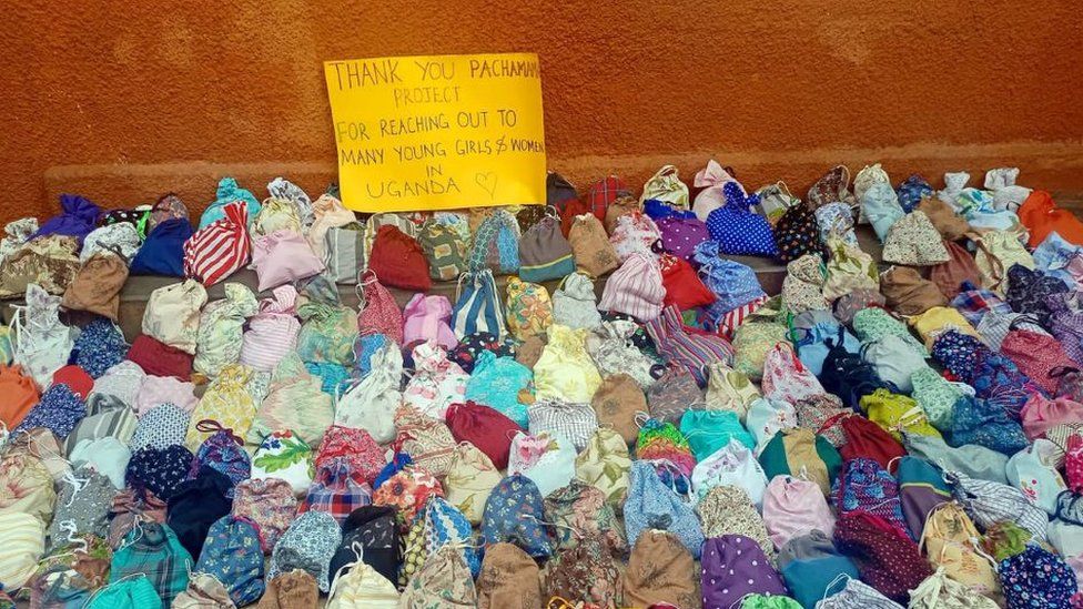 Reusable pads in front of a sign of thanks in Uganda