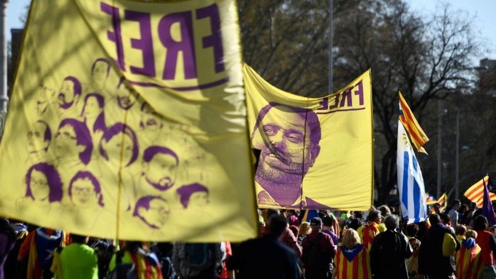 Demonstrators in Madrid carry banners showing portraits of Catalan leaders on trial. Photo: 16 March 2019