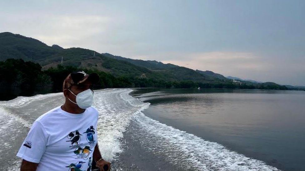 A local boatman, Lalo Escamilla, sails in Puerto Escondido