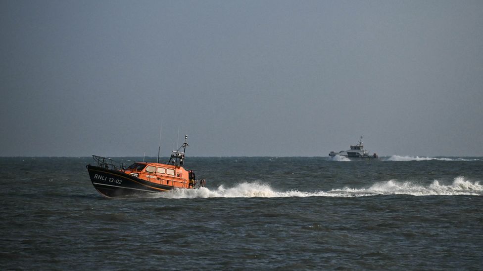 Dungeness Lifeboat at sea with a Border Force vessel behind it