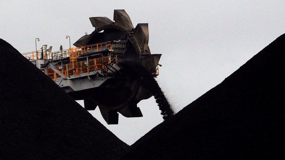 A machine places coal in stockpiles at a coal port in Newcastle, Australia