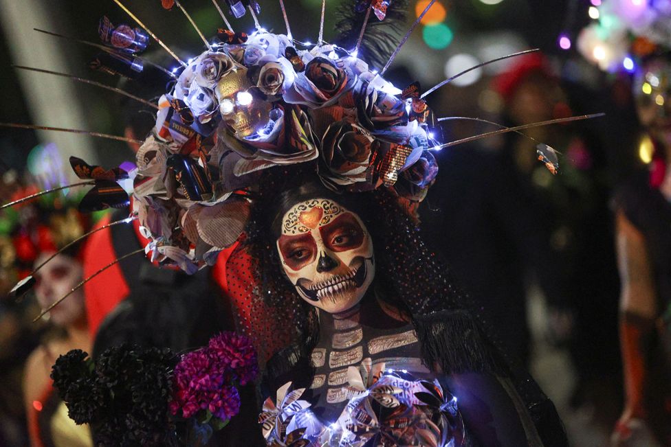 Participants dressed as the popular Mexican figure Catrina perform during a parade, as part of the Day of the Dead celebrations, in Mexico City, Mexico 22 October, 2023.