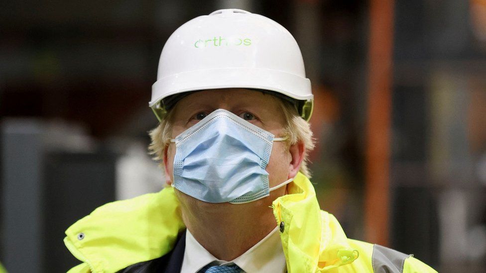 Boris Johnson in a mask and hard hat