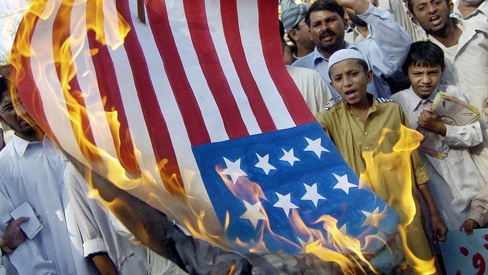 Pakistani activists and supporters of the six party Islamic alliance, Muttahida Majlis-e-Amal (MMA), set a makeshift US flag on fire during an anti-US demonstration in Lahore, 27 May 2005