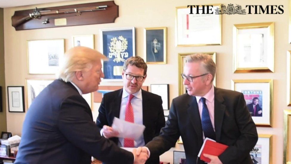 Mr Trump shaking hands with Michael Gove during the interview.