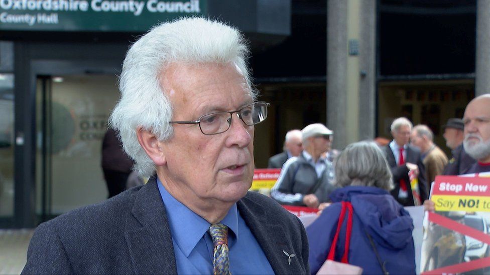 A picture of Chris Church campaigning in front of Oxfordshire County Council