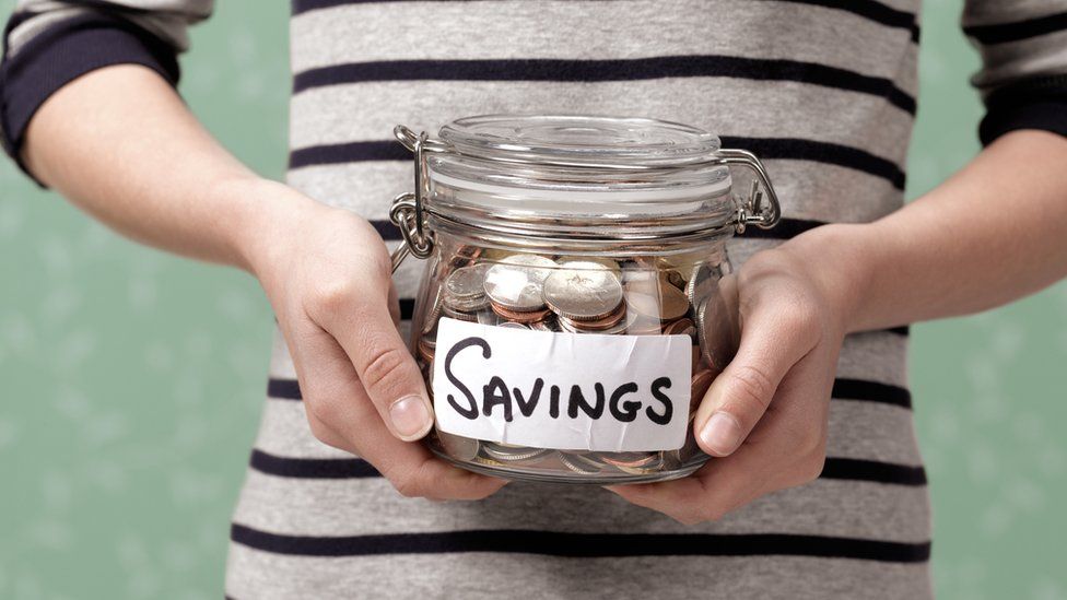 Woman holding savings jar