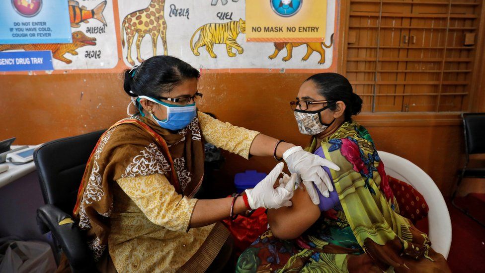A health care worker receives a dose of COVISHIELD, a COVID-19 vaccine manufactured by Serum Institute of India