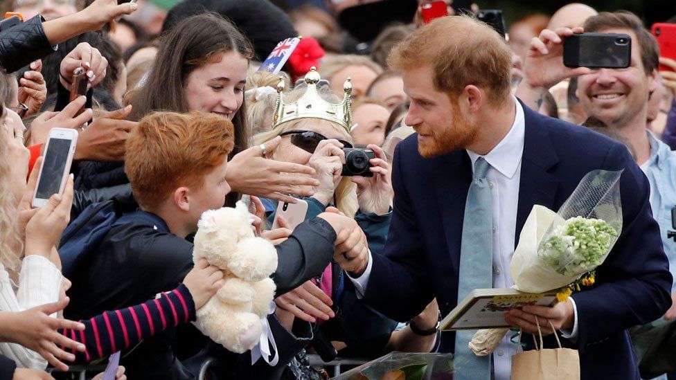 Prince Harry meeting a boy with red hair at the Royal Botanical Gardens in Melbourne