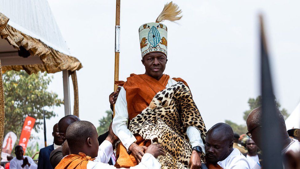 Kabaka (King) Ronald Muwenda Mutebi II being carried on the shoulders of some men during his coronation on 31 July 2023