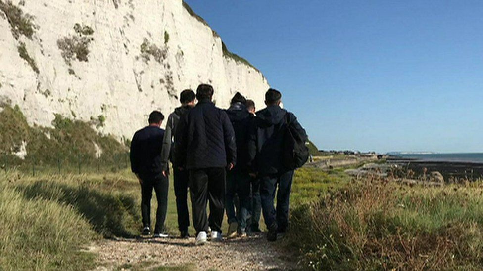 Migrants onshore after they arrived in a dinghy at Kingsdown, Kent