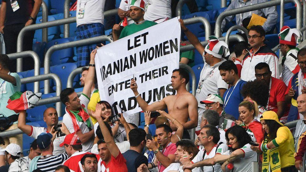 Iran's fans hold up a banner reading "Let Iranian women enter theirs stadiums" at 2018 World Cup match between Morocco and Iran at the Saint Petersburg Stadium in Saint Petersburg on June 15, 2018.