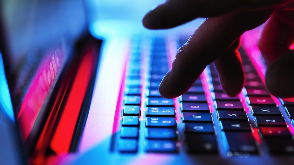 Person typing on computer keyboard