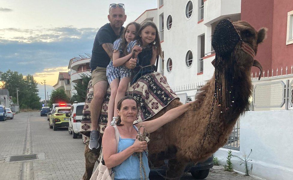 Emma Baxter and Daniel Metcalf with their daughters with a camel on holiday in Turkey