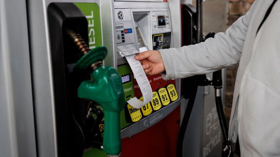 A customer takes a receipt after refueling a vehicle at a Wawa gas station in Fairfax, Virginia, US, on Thursday, Feb. 22, 2024.