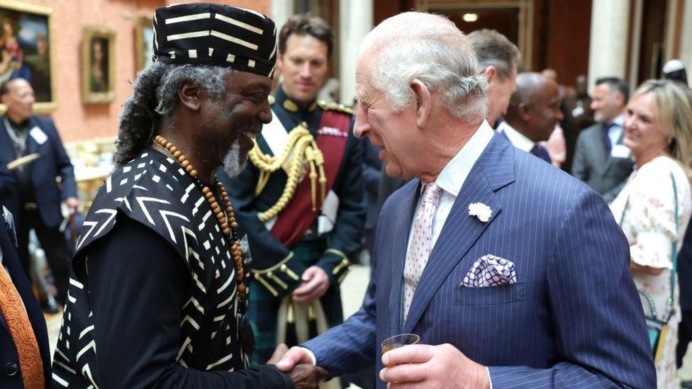 King Charles shakes hands with a guest during a reception at Buckingham Palace in London to celebrate the Windrush Generation