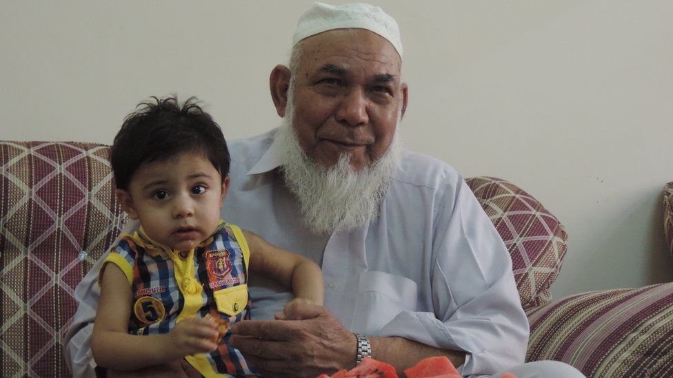 Mehmood Ali Khan at home, with his grandson