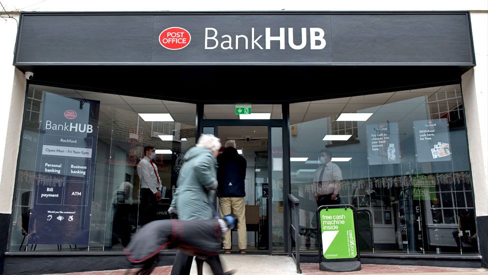 A pedestrian walks her dog past the new Bank Hub on 7 April 2021 in Rochford, England