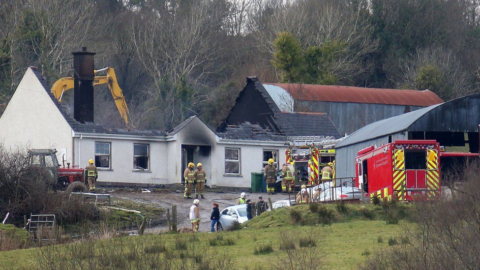 Firefighters at the house that was gutted by the fire